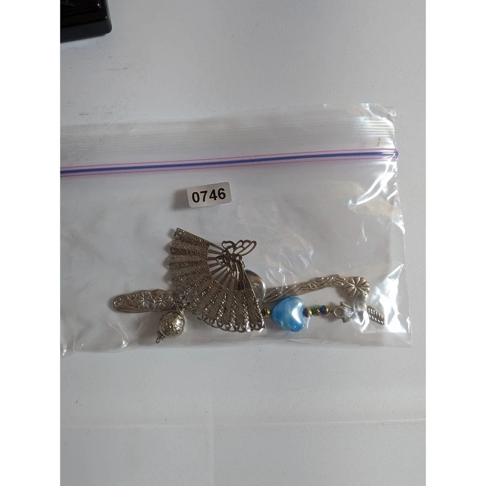 metal hook bookmark with a beaded charm featuring a fan pendant and a blue heart